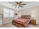 Spacious bedroom with ceiling fan, wood bed frame, and ample closet space at 37029 N Andravida Dr, San Tan Valley, AZ 85140