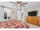 Main bedroom with large dresser and sliding barn door to bathroom at 37029 N Andravida Dr, San Tan Valley, AZ 85140