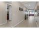 Light-filled hallway with tile floors and access to other rooms at 37029 N Andravida Dr, San Tan Valley, AZ 85140