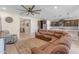 Relaxing living room featuring a large sectional sofa and ceiling fan at 37029 N Andravida Dr, San Tan Valley, AZ 85140