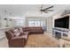 Relaxing living room featuring a sectional sofa and fireplace at 37029 N Andravida Dr, San Tan Valley, AZ 85140