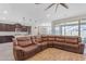 Open concept living room with a large sectional sofa and kitchen views at 37029 N Andravida Dr, San Tan Valley, AZ 85140