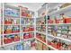 Organized pantry with numerous shelves and red storage bins at 37029 N Andravida Dr, San Tan Valley, AZ 85140