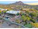 Stunning aerial view of a luxurious estate with a pool and putting green, nestled in a scenic mountain setting at 38844 N Spur Cross Rd, Cave Creek, AZ 85331