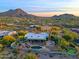 Luxury estate home aerial view, showcasing a large pool, expansive backyard, and breathtaking mountain backdrop at 38844 N Spur Cross Rd, Cave Creek, AZ 85331