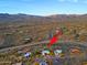 Wider aerial view showing the property location in relation to the surrounding desert and community at 38844 N Spur Cross Rd, Cave Creek, AZ 85331