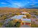 Aerial view of a home with a pool and attached garage, surrounded by desert landscape and mountain views at 38844 N Spur Cross Rd, Cave Creek, AZ 85331