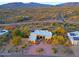 Aerial view showcasing a single-story home with a circular driveway and desert landscaping at 38844 N Spur Cross Rd, Cave Creek, AZ 85331