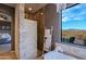 Bathroom with walk-in shower, soaking tub, and mountain views at 38844 N Spur Cross Rd, Cave Creek, AZ 85331