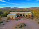 Front view of a stunning home with desert landscaping and mountain views at 38844 N Spur Cross Rd, Cave Creek, AZ 85331