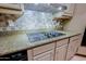 Modern kitchen with granite countertops and a sleek glass cooktop at 38844 N Spur Cross Rd, Cave Creek, AZ 85331