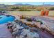 Inviting pool with waterfall feature and mountain views at 38844 N Spur Cross Rd, Cave Creek, AZ 85331