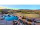 Inviting pool with waterfall feature and mountain backdrop at 38844 N Spur Cross Rd, Cave Creek, AZ 85331