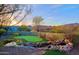 Enjoy the putting green and mountain views from the backyard at 38844 N Spur Cross Rd, Cave Creek, AZ 85331