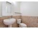 Updated bathroom with pedestal sink and stone tile at 3982 E Sandpiper Dr, Phoenix, AZ 85050