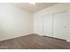 Spacious bedroom with double door closet and wood-look floors at 3982 E Sandpiper Dr, Phoenix, AZ 85050