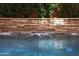 Stone wall waterfall feature adding serenity to the pool at 3982 E Sandpiper Dr, Phoenix, AZ 85050