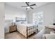 Guest bedroom with a metal bed frame and wood desk at 40715 N Lytham Ct, Phoenix, AZ 85086