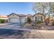 Beautiful home exterior with three-car garage and desert landscaping at 40715 N Lytham Ct, Phoenix, AZ 85086