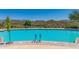 Inviting community pool with ample lounge chairs and mountain backdrop at 40715 N Lytham Ct, Phoenix, AZ 85086