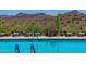 Community pool with lounge chairs and mountain views at 40715 N Lytham Ct, Phoenix, AZ 85086