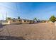 Backyard view of house with gravel and partial fence at 5452 E University Dr, Mesa, AZ 85205