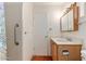 Bathroom features wood vanity and tiled walls at 5452 E University Dr, Mesa, AZ 85205