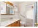 Bathroom with wood vanity and tiled shower/tub at 5452 E University Dr, Mesa, AZ 85205