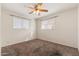 Bright bedroom featuring ceiling fan and large windows at 5452 E University Dr, Mesa, AZ 85205