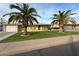 Front view of a ranch home with a two-car garage and lush lawn at 5452 E University Dr, Mesa, AZ 85205