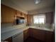 Kitchen area with wood cabinets, white countertops, and a microwave at 5452 E University Dr, Mesa, AZ 85205