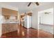 Kitchen with white appliances and wood cabinets at 5452 E University Dr, Mesa, AZ 85205