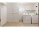 Laundry room with washer, dryer, and built-in storage at 5452 E University Dr, Mesa, AZ 85205