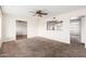 Spacious living room featuring carpet flooring and ceiling fan at 5452 E University Dr, Mesa, AZ 85205