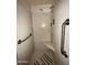 Clean shower with grab bars and tiled walls at 5452 E University Dr, Mesa, AZ 85205