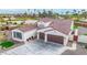 Aerial view of a house with a two-car garage and a landscaped yard at 5609 W Posse Dr, Eloy, AZ 85131