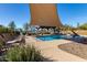 Community pool with shade structures and lounge chairs at 5609 W Posse Dr, Eloy, AZ 85131