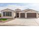 Craftsman style home with two-car garage and landscaped front yard at 5609 W Posse Dr, Eloy, AZ 85131