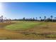 Scenic golf course with palm trees and mountain views at 5609 W Posse Dr, Eloy, AZ 85131