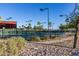 Tennis courts with players and landscaping at 5609 W Posse Dr, Eloy, AZ 85131