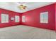 Red-walled bedroom with carpet flooring and ceiling fan at 7110 W Villa Lindo Dr, Peoria, AZ 85383