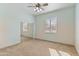 Bright bedroom with mirrored closet doors and ceiling fan at 7110 W Villa Lindo Dr, Peoria, AZ 85383