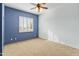 Bedroom with ceiling fan and blue accent wall at 7110 W Villa Lindo Dr, Peoria, AZ 85383