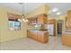 Kitchen boasts wood cabinets, granite countertops and tile floors at 7110 W Villa Lindo Dr, Peoria, AZ 85383