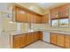 Kitchen with wood cabinets, granite countertops and tile floors at 7110 W Villa Lindo Dr, Peoria, AZ 85383