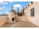 Outdoor patio with a built-in fireplace and brick paving at 7110 W Villa Lindo Dr, Peoria, AZ 85383