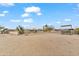 Expansive desert lot with a view of the house and animal shelter at 7110 W Villa Lindo Dr, Peoria, AZ 85383