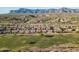 Aerial view of homes and a golf course near mountains at 7227 E Texas Ebony Dr, Gold Canyon, AZ 85118