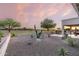 Landscaped backyard with covered patio, offering a serene golf course view at 7227 E Texas Ebony Dr, Gold Canyon, AZ 85118