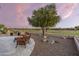 Landscaped backyard with seating area and built-in grill, overlooking golf course at 7227 E Texas Ebony Dr, Gold Canyon, AZ 85118